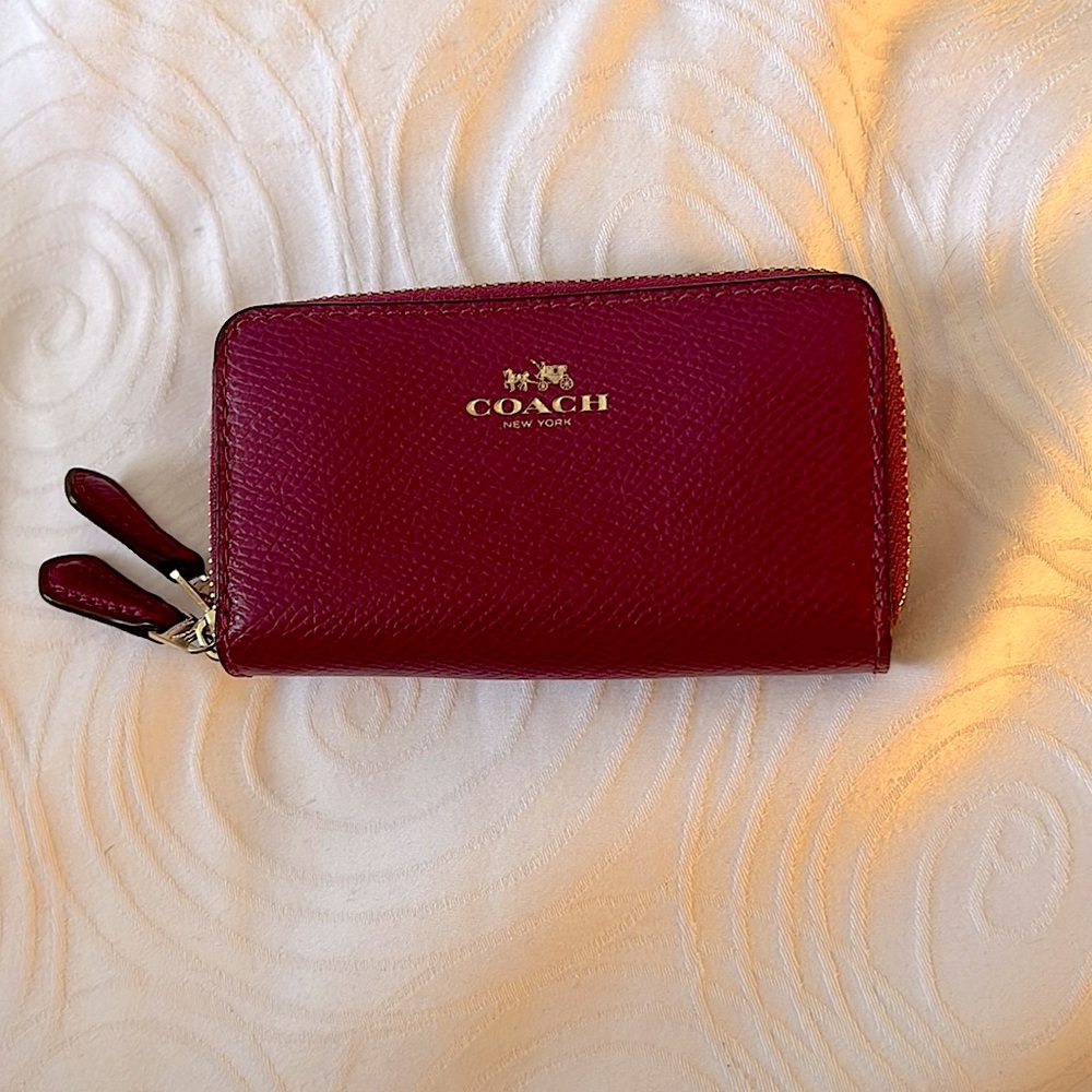 Coach burgundy mini wallet with gold accidents on it